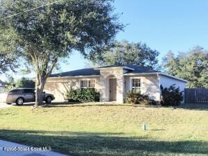 single story home featuring a front lawn