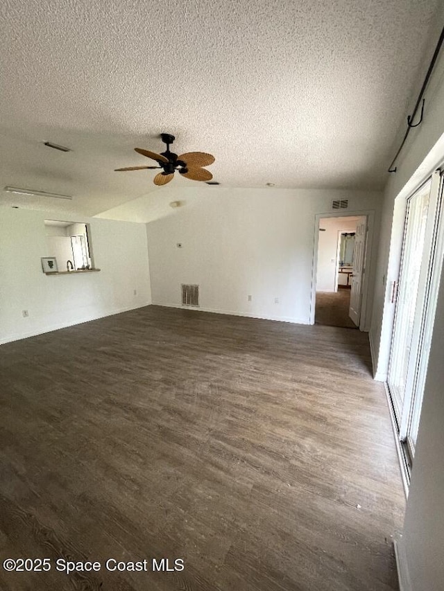 409 Bougainvillea St NW, Palm Bay, FL 32907 - unfurnished room featuring healthy amount of natural light, wood finished floors, a textured ceiling, a ceiling fan, and lofted ceiling