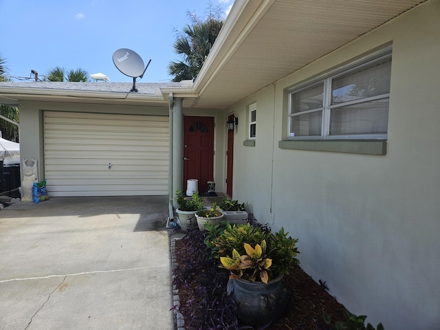 7181 Blue Shore Rd, Grant, FL 32949 - property entrance with driveway, an attached garage, and stucco siding