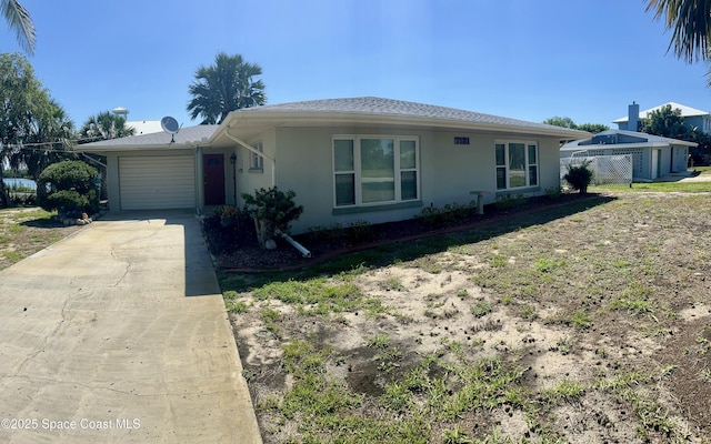 7181 Blue Shore Rd, Grant, FL 32949 - ranch-style home with concrete driveway, an attached garage, stucco siding, and fence