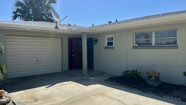 7181 Blue Shore Rd, Grant, FL 32949 - entrance to property with driveway, a garage, stucco siding, and roof with shingles