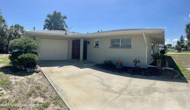 7181 Blue Shore Rd, Grant, FL 32949 - view of front facade with driveway, a garage, and stucco siding