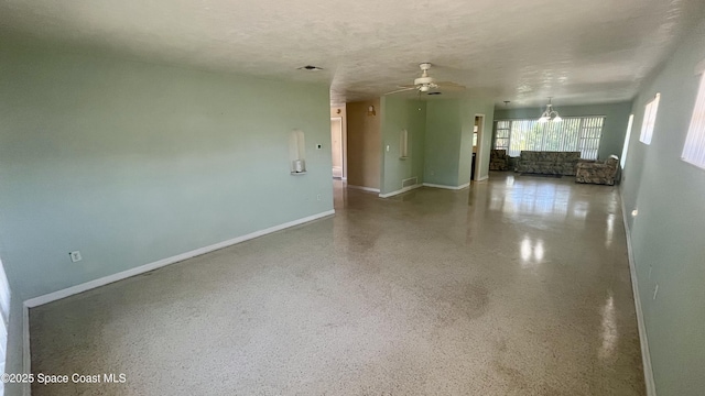 7181 Blue Shore Rd, Grant, FL 32949 - unfurnished living room with ceiling fan, baseboards, and speckled floor