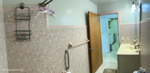 7181 Blue Shore Rd, Grant, FL 32949 - bathroom featuring tile walls, vanity, wainscoting, and tiled shower