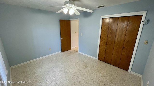 7181 Blue Shore Rd, Grant, FL 32949 - unfurnished bedroom featuring a closet, baseboards, ceiling fan, and speckle patterned floor