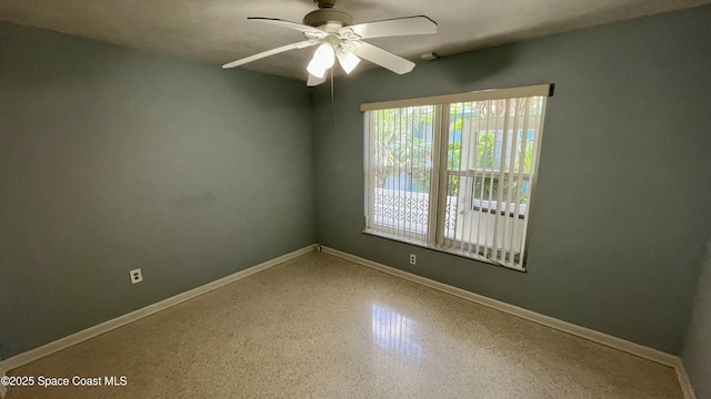 7181 Blue Shore Rd, Grant, FL 32949 - spare room with baseboards, a ceiling fan, and speckle patterned floor