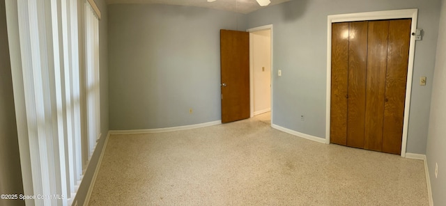 7181 Blue Shore Rd, Grant, FL 32949 - unfurnished bedroom with baseboards, speckled floor, and a closet