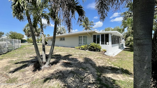7181 Blue Shore Rd, Grant, FL 32949 - back of house with a sunroom and stucco siding