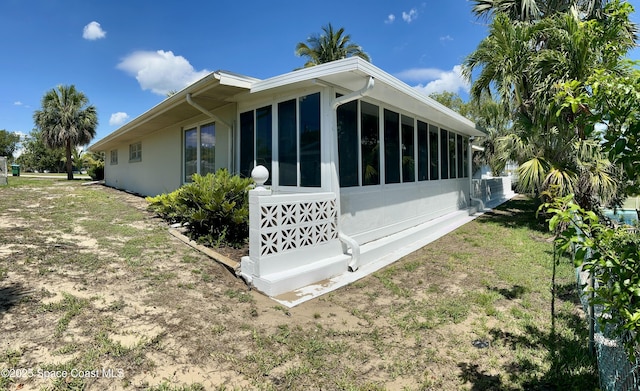 7181 Blue Shore Rd, Grant, FL 32949 - view of property exterior with a sunroom