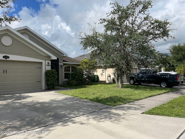 4125 Aria Dr, Melbourne, FL 32904 - ranch-style home with driveway, an attached garage, a front lawn, and stucco siding