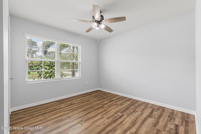 unfurnished room featuring wood finished floors, baseboards, and ceiling fan