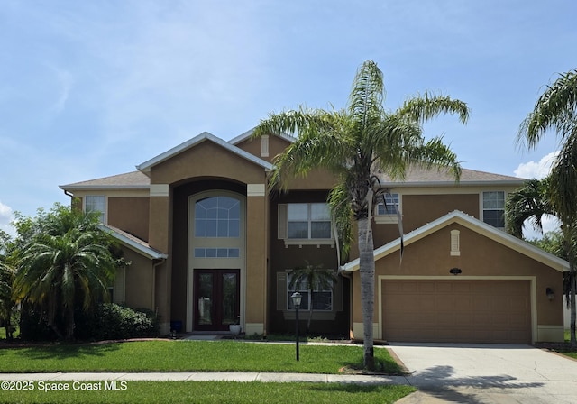 4408 Chastain Dr, Melbourne, FL 32940 - view of front of house with french doors, stucco siding, concrete driveway, and a front lawn