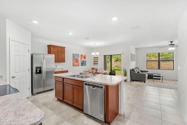 369 Coyote Dr, Cocoa, FL 32927 - kitchen featuring stainless steel appliances, a sink, brown cabinetry, light countertops, and a chandelier