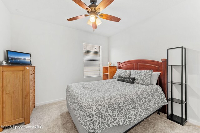 369 Coyote Dr, Cocoa, FL 32927 - bedroom featuring light carpet, baseboards, and ceiling fan