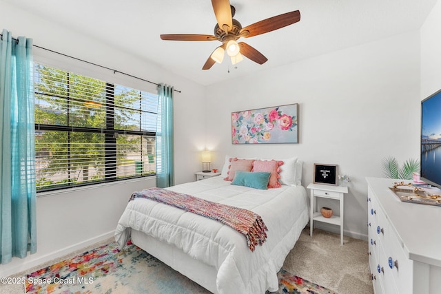 369 Coyote Dr, Cocoa, FL 32927 - bedroom with baseboards, light colored carpet, and ceiling fan