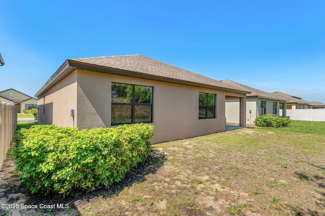 369 Coyote Dr, Cocoa, FL 32927 - rear view of house featuring stucco siding and a shingled roof