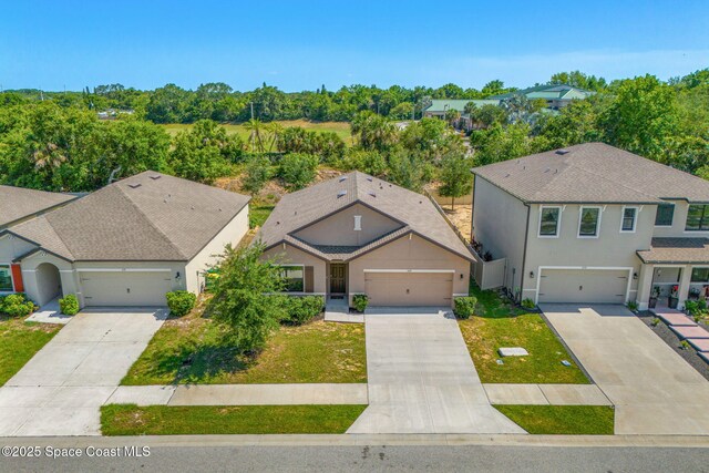 369 Coyote Dr, Cocoa, FL 32927 - view of front facade with stucco siding, driveway, and a garage