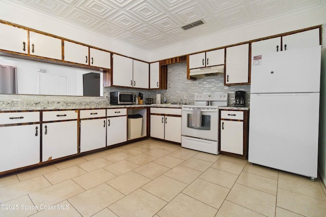 326 Pierce Ave, Cape Canaveral, FL 32920 - kitchen with white appliances, under cabinet range hood, an ornate ceiling, white cabinetry, and tasteful backsplash