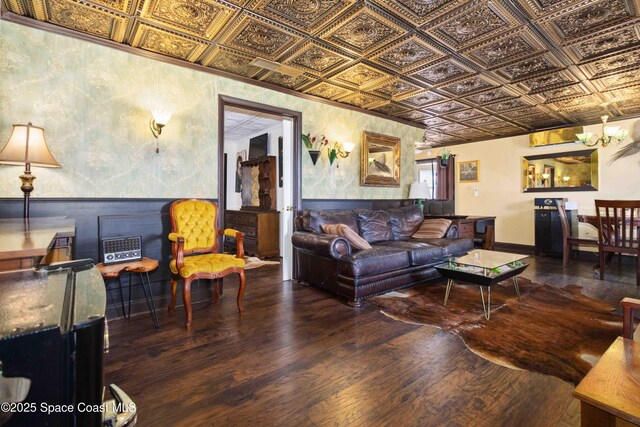 326 Pierce Ave, Cape Canaveral, FL 32920 - living room featuring an ornate ceiling, hardwood / wood-style floors, a wainscoted wall, and a chandelier