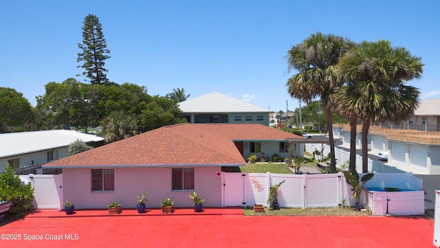 326 Pierce Ave, Cape Canaveral, FL 32920 - view of front facade with a gate, roof with shingles, and stucco siding