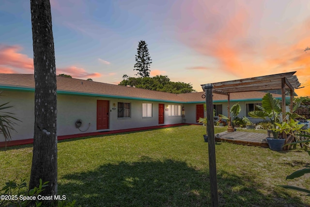 326 Pierce Ave, Cape Canaveral, FL 32920 - view of front of property featuring stucco siding, a pergola, and a front lawn