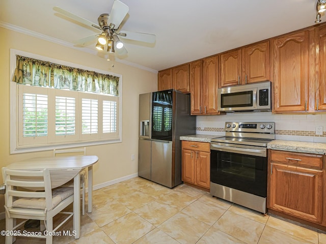 5720 Marina Dr Unit 2, Sebastian, FL 32958 - kitchen featuring stainless steel appliances, brown cabinetry, ornamental molding, a ceiling fan, and light tile patterned flooring