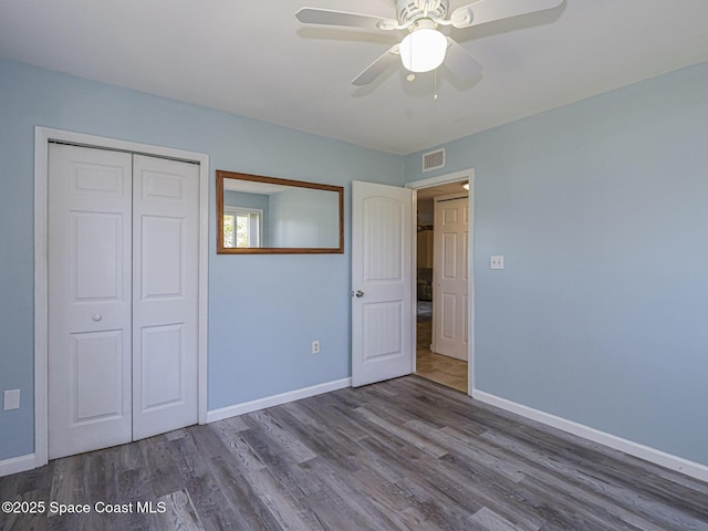 5720 Marina Dr Unit 2, Sebastian, FL 32958 - unfurnished bedroom with wood finished floors, a closet, baseboards, and ceiling fan