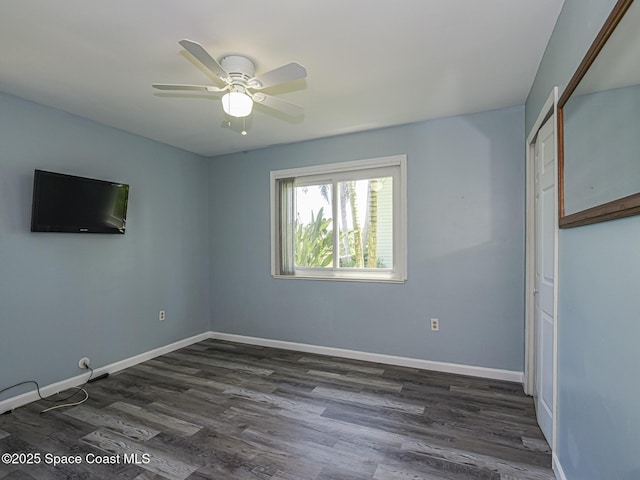 5720 Marina Dr Unit 2, Sebastian, FL 32958 - empty room featuring dark wood-type flooring, a ceiling fan, and baseboards