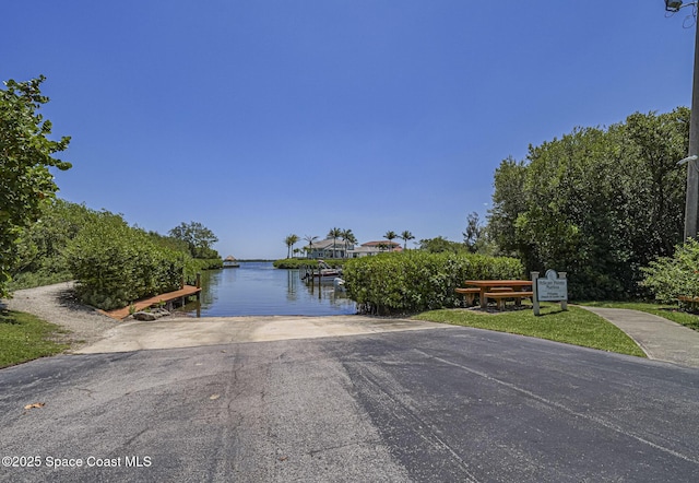 5720 Marina Dr Unit 2, Sebastian, FL 32958 - view of property hidden behind natural elements with a boat ramp, a water view, and a dock