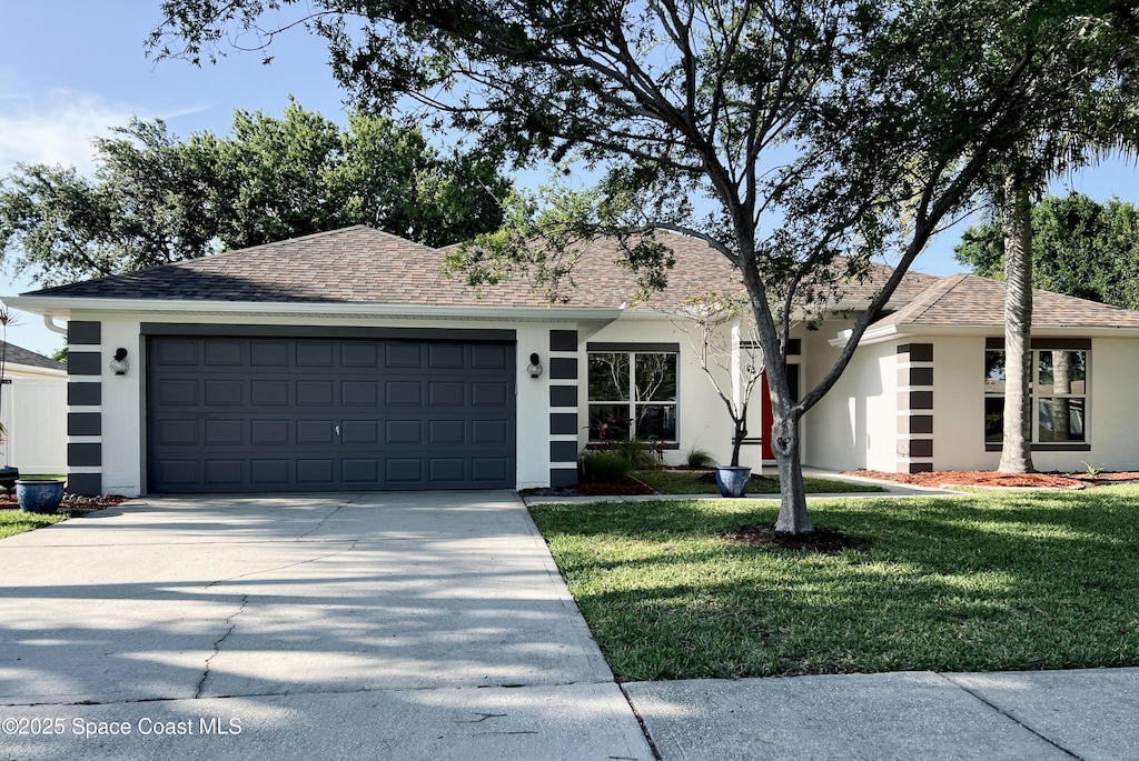 ranch-style home with stucco siding, driveway, a front lawn, a garage, and roof with shingles