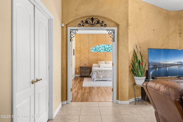 bedroom featuring light tile patterned flooring and baseboards