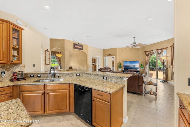 kitchen featuring a sink, black dishwasher, light stone counters, brown cabinets, and recessed lighting