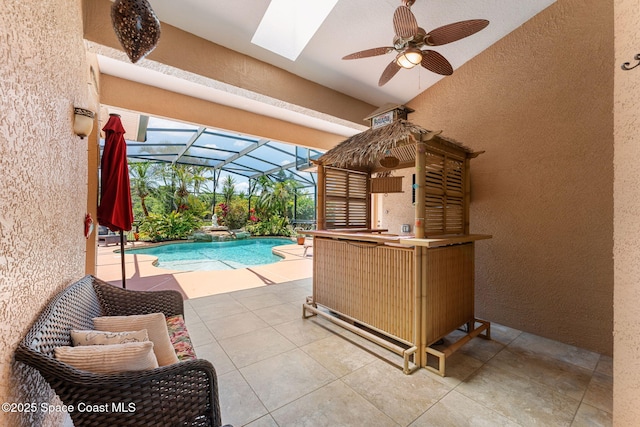 view of patio with ceiling fan, an outdoor pool, and glass enclosure