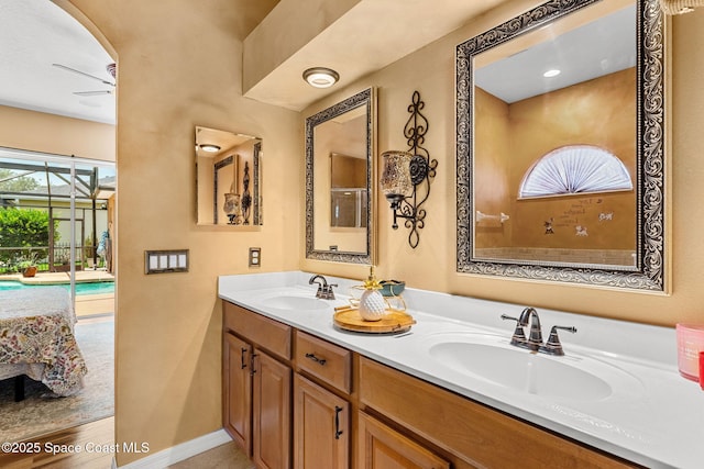 full bath with double vanity, baseboards, and ensuite bathroom