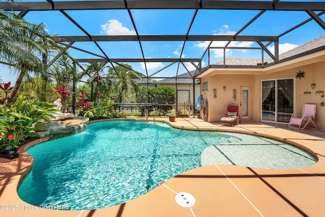 swimming pool with a patio and glass enclosure