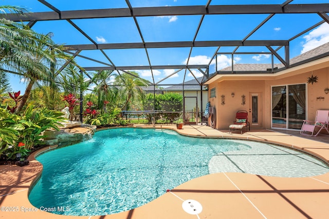 swimming pool featuring a patio area and glass enclosure