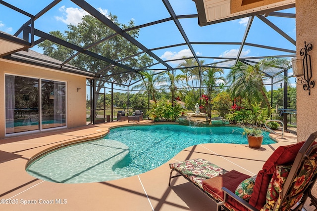 outdoor pool featuring a patio area and a lanai