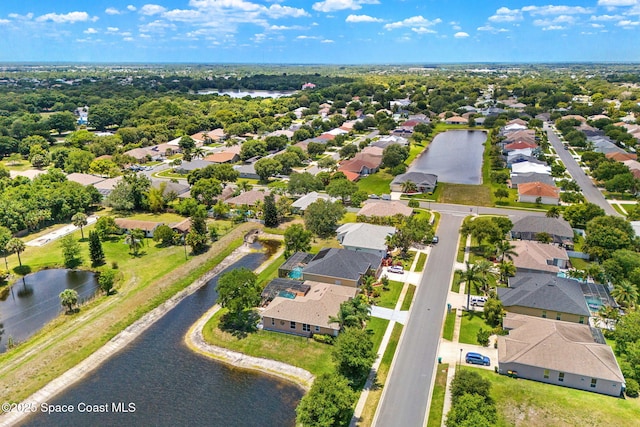 aerial perspective of suburban area with a nearby body of water