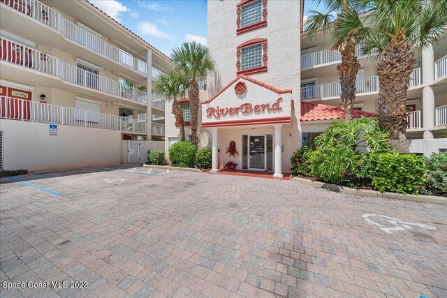 3360 S Atlantic Ave Unit 301, Cocoa Beach, FL 32931 - view of apartment building / complex featuring uncovered parking