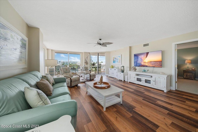 3360 S Atlantic Ave Unit 301, Cocoa Beach, FL 32931 - living area featuring wood finished floors, a ceiling fan, and a textured ceiling