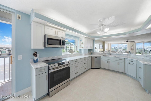 3360 S Atlantic Ave Unit 301, Cocoa Beach, FL 32931 - kitchen with appliances with stainless steel finishes, a sink, a ceiling fan, and light countertops