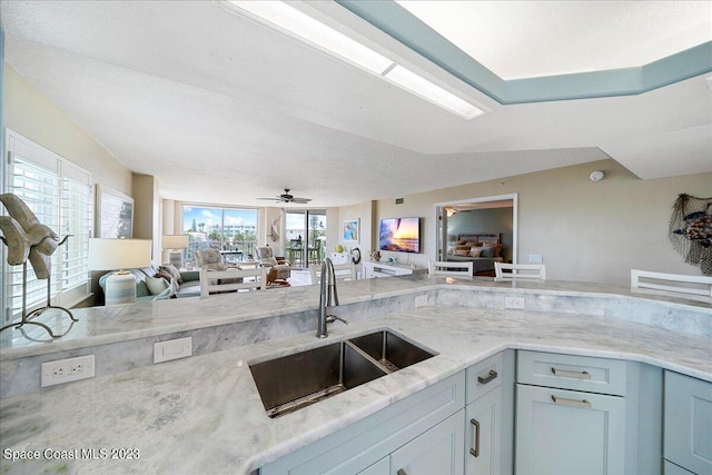3360 S Atlantic Ave Unit 301, Cocoa Beach, FL 32931 - kitchen featuring a sink, open floor plan, and light stone counters