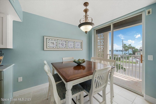 3360 S Atlantic Ave Unit 301, Cocoa Beach, FL 32931 - dining area featuring baseboards and light tile patterned flooring