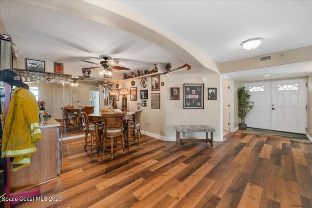 3360 S Atlantic Ave Unit 301, Cocoa Beach, FL 32931 - dining room featuring wood finished floors, baseboards, ceiling fan, and a textured ceiling
