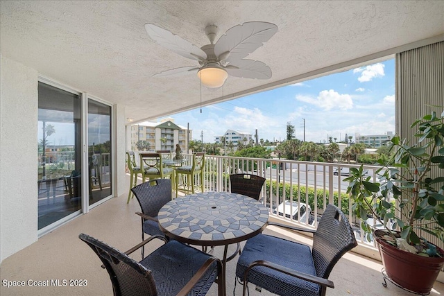 3360 S Atlantic Ave Unit 301, Cocoa Beach, FL 32931 - balcony with ceiling fan and outdoor dining area