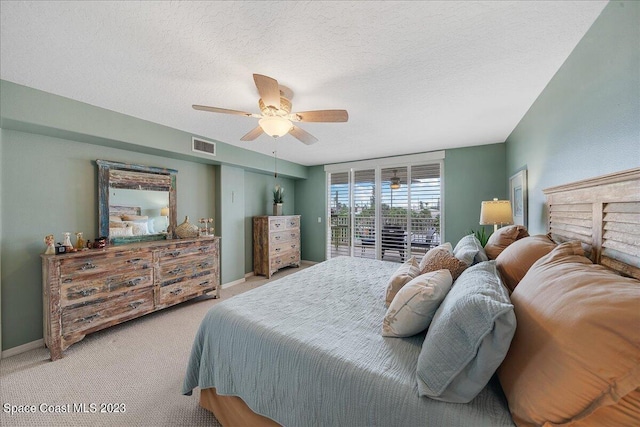 3360 S Atlantic Ave Unit 301, Cocoa Beach, FL 32931 - carpeted bedroom with access to exterior, a ceiling fan, and a textured ceiling
