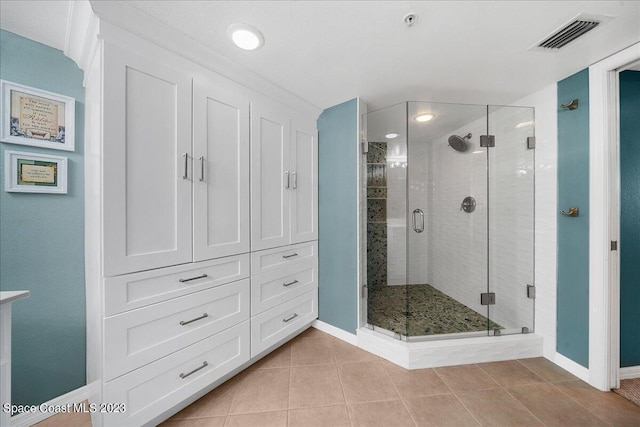 3360 S Atlantic Ave Unit 301, Cocoa Beach, FL 32931 - bathroom with a shower stall, baseboards, and tile patterned flooring