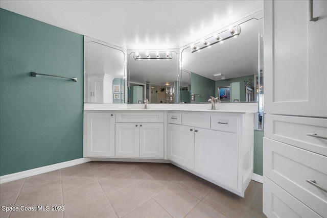 3360 S Atlantic Ave Unit 301, Cocoa Beach, FL 32931 - bathroom featuring baseboards, tile patterned flooring, and double vanity