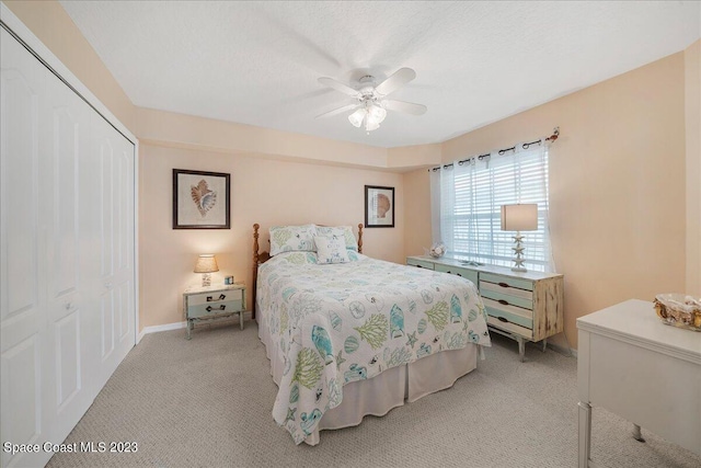 3360 S Atlantic Ave Unit 301, Cocoa Beach, FL 32931 - bedroom featuring light colored carpet, a closet, ceiling fan, and baseboards