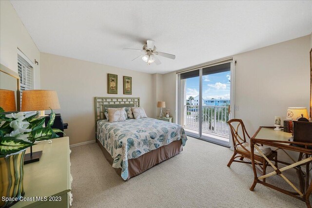 3360 S Atlantic Ave Unit 301, Cocoa Beach, FL 32931 - bedroom featuring access to outside, light colored carpet, baseboards, ceiling fan, and floor to ceiling windows